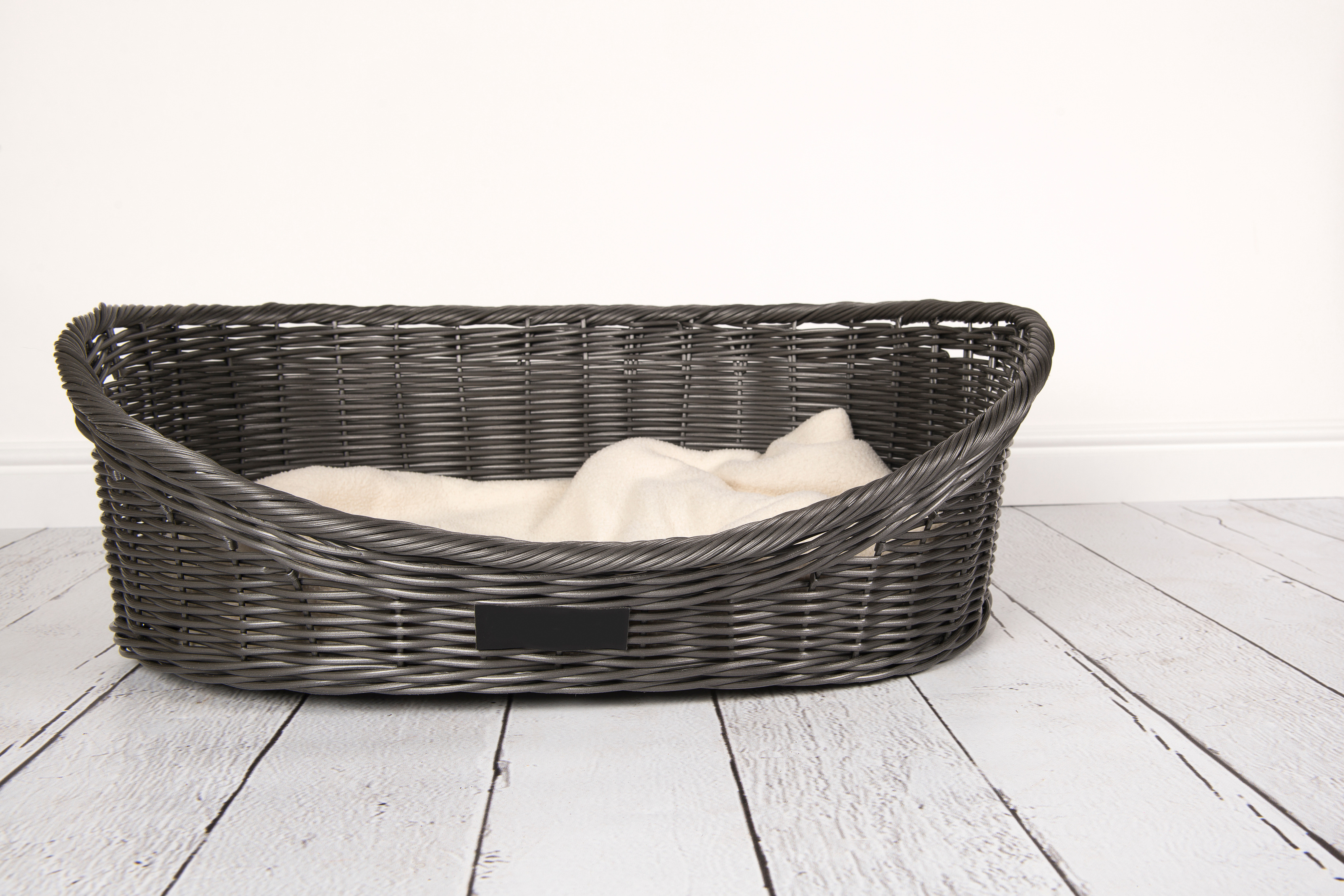 Empty dog bed in a white studio interior